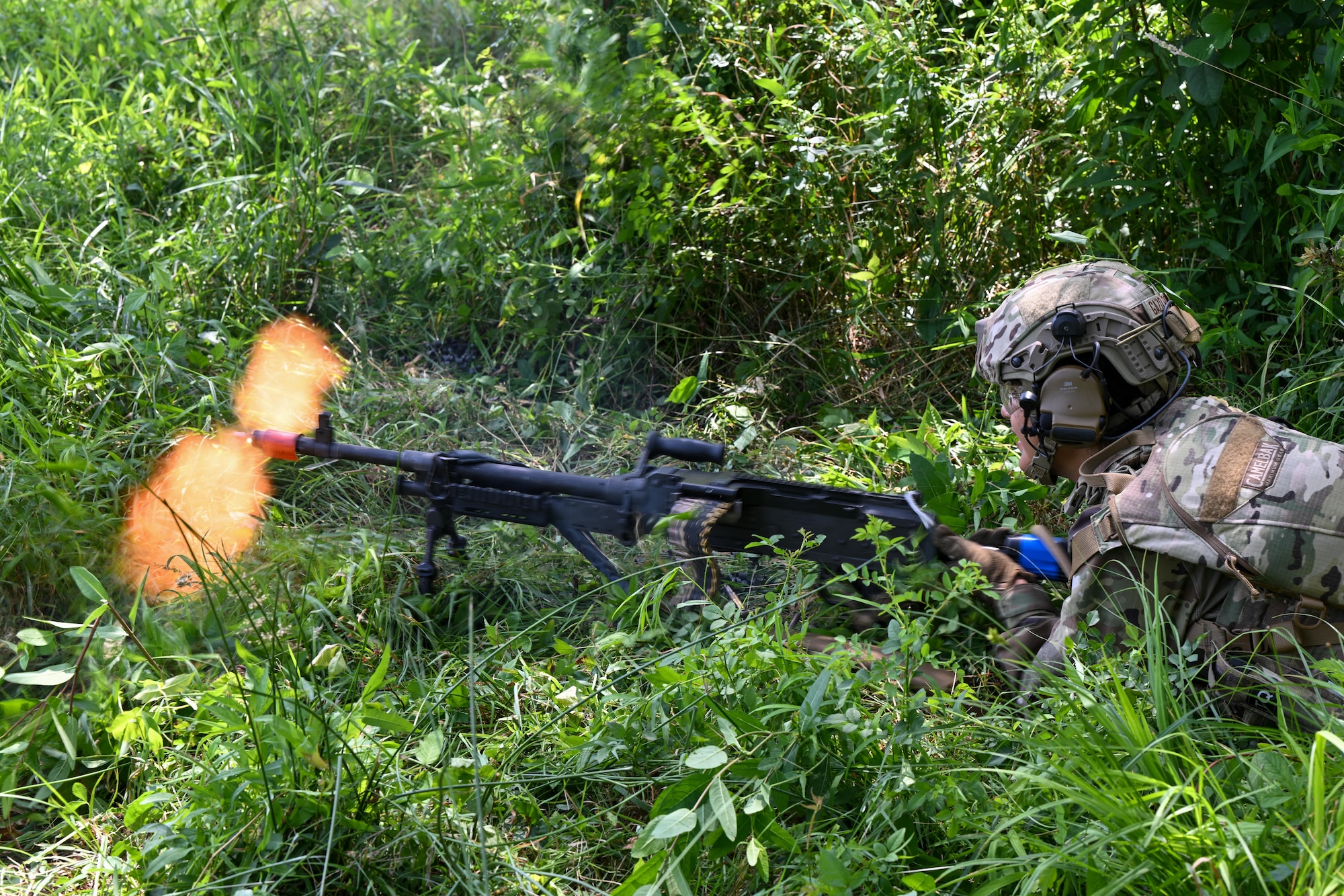 An Integrated Defense Leadership Course student fires at opposing forces during an engagement at the Slagle Drop Zone at Camp James A. Garfield Joint Military Training Center, Ohio, during an exercise, July 24, 2025.