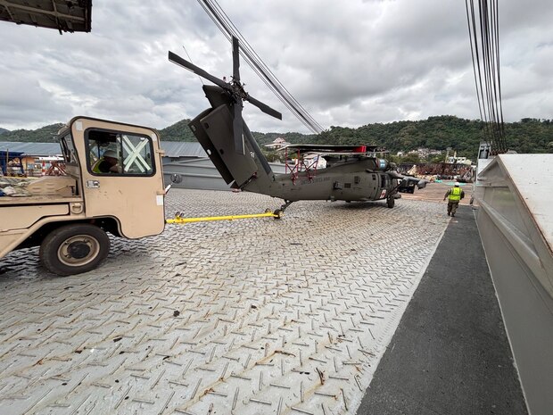 U.S. Army soldiers from 1-52 General Support Aviation Battalion, 11th Airborne Division, offload a UH-60 Black Hawk helicopter from the Cape Hudson Vessel during port operations in support of Super Garuda Shield at the port of Panjang, Indonesia, during Super Garuda Shield 25, August 13, 2025.