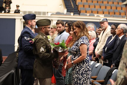 Kathleen Andonie accepts flowers during a combined change of command and retirement ceremony Aug. 9, 2025, at DAR Constitution Hall. Maj. Gen. John C. Andonie, outgoing Commanding General (Interim) of the District of Columbia National Guard, gifted his wife flowers in honor of the support she has provided during his time in service.