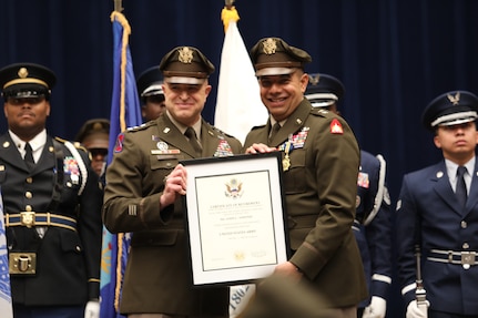 U.S. Army Lt. Gen. Jonathan Stubbs, Director of the Army National Guard (left) presents a certificate of retirement to  U.S. Army Maj. Gen. John C. Andonie, outgoing commanding general (interim) for the D.C. National Guard, during a combined change of command and retirement ceremony Aug. 9, 2025, at DAR Constitution Hall. Andonie retired from the Air Force after 35 years of service.