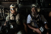U.S. Marine Corps Lance Cpl. Juaquin Greaves, a combat videographer with Headquarters Marine Corps Communication Directorate, and a local firefighter, participate in an outreach and engagement Flight as part of Marine Week Boston 2025 in Boston, Mass., Aug. 22, 2025. The Marine Corps is celebrating its 250th birthday by including activations across the city featuring aircraft, equipment, recruiting opportunities, and public engagements. (U.S. Marine Corps photo by Lance Cpl. Alondra Y. Lopez Gonzalez)