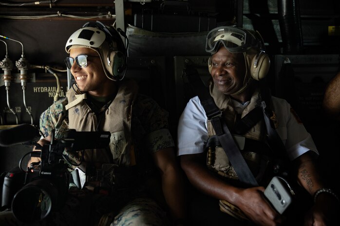 U.S. Marine Corps Lance Cpl. Juaquin Greaves, a combat videographer with Headquarters Marine Corps Communication Directorate, and a local firefighter, participate in an outreach and engagement Flight as part of Marine Week Boston 2025 in Boston, Mass., Aug. 22, 2025. The Marine Corps is celebrating its 250th birthday by including activations across the city featuring aircraft, equipment, recruiting opportunities, and public engagements. (U.S. Marine Corps photo by Lance Cpl. Alondra Y. Lopez Gonzalez)