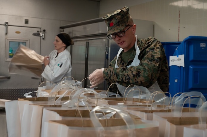 U.S. Marine Corps Pfc. James Smith, a native of Toledo, Ohio, and an airborne and air delivery specialist assigned to Special Purpose Marine Air-Ground Task Force-250, packages food at Community Servings, a non-profit organization that delivers meals to food-insecure homes in the city, during Marine Week Boston, Aug. 22, 2025. Marines stationed across the globe commemorate the 250th anniversary of the Marine Corps, honoring a distinguished legacy of service, sacrifice, and unwavering fidelity to both the nation and fellow Marines. (U.S. Marine Corps photo by LCpl. Matthew McDonnell)