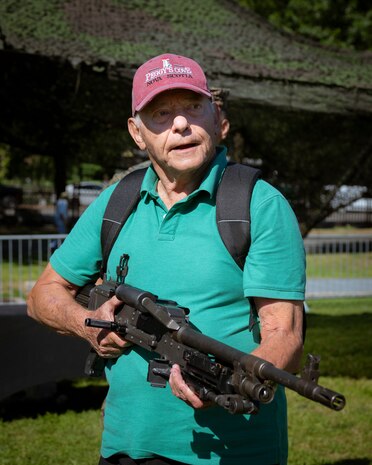 A Boston resident learns about the M240B machine gun at Boston Common during Marine Week Boston, Aug. 22, 2025. Marines display various equipment at the static display showcasing the Marine Corps capabilities to the public. In celebration of 250 years of proud tradition, Marines around the world unite to honor their shared heritage - a legacy defined by honor, courage, and commitment. (U.S. Marine Corps photo by Cpl. Vincent Needham)