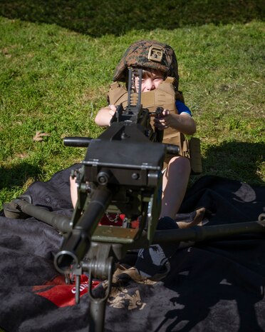 A Boston resident gets behind a MK19 grenade launcher at Boston Common during Marine Week Boston, Aug. 22, 2025. Marines display various equipment at the static display showcasing the Marine Corps capabilities to the public. In celebration of 250 years of proud tradition, Marines around the world unite to honor their shared heritage - a legacy defined by honor, courage, and commitment. (U.S. Marine Corps photo by Cpl. Vincent Needham)