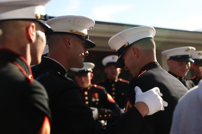 U.S. Marine Corps Capt. Ford Higgins, left, platoon commander of the United States Marine Corps Silent Drill Platoon, Marine Barracks Washington, speaks with Lance Cpl. Trey Earls, a rifleman within the platoon, after a performance during Marine Week Boston in Marblehead, Massachusetts, Aug. 21, 2025. The year 2025 marks the 250th anniversary of the United States Marine Corps, a milestone that highlights the legacy, transformation and enduring spirit of the Corps since 1775. Throughout the year, Marines across the globe will commemorate this anniversary by honoring the service and sacrifice of those who served before them and by remaining faithful to the motto Semper Fidelis. (U.S. Marine Corps photo by Lance Cpl. Brynn L. Bouchard)