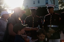 U.S. Marine Corps Lance Cpl. Brian Quintanilladiaz, and Lance Cpl. Jalen Jones, both rifleman with with the United States Marine Corps Silent Drill Platoon, Marine Barracks Washington, interact with community members during Marine Week Boston in Marblehead, Massachusetts, Aug. 21, 2025. The year 2025 marks the 250th anniversary of the United States Marine Corps, a milestone that highlights the legacy, transformation and enduring spirit of the Corps since 1775. Throughout the year, Marines across the globe will commemorate this anniversary by honoring the service and sacrifice of those who served before them and by remaining faithful to the motto Semper Fidelis. (U.S. Marine Corps photo by Lance Cpl. Brynn L. Bouchard)