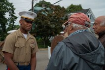 U.S. Marine Corps 1st Lt. Shonquez Caldwell a logistics officer with the Special Purpose Marine Air-Ground Task Force-250 speaks with Louis Cappuccio, son of U.S. Marine Corps Cpl. Joseph J. Cappuccio, who served in the Battle of Iwo Jima, at a WWII dedication during Marine Week Boston 2025, Aug. 21, 2025. Joseph J. Cappuccio Square was renamed in honor of Cpl. Cappuccio’s service. As the Marine Corps marks its 250th year, Marines worldwide observe this historic milestone, paying tribute to generations of valor, duty, and the enduring spirit of Semper Fidelis. (U.S. Marine Corps photo by Lance Cpl. Matthew A. McDonnell)