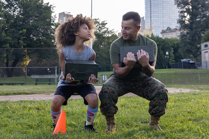 U.S. Marine Corps Sgt. Maj. Efrain Barrientos, right, a native of Princeton, N.J., assigned to Special Purpose Marine Air-Ground Task Force-250, motivates an event attendee during Marine Week Boston, Aug. 23, 2025. Marines stationed across the globe commemorate the 250th anniversary of the Marine Corps, honoring a distinguished legacy of service, sacrifice, and unwavering fidelity to both the nation and fellow Marines. (U.S. Marine Corps photo by blank)