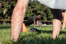 U.S. Marine Corps Lance Cpl. Michael Pepperling, a native of Anchorage, Alaska, a motor vehicle operator assigned to Special Purpose Marine Air-Ground Task Force-250, performs push-ups with event attendees during Marine Week Boston, Aug. 23, 2025. Marines stationed across the globe commemorate the 250th anniversary of the Marine Corps, honoring a distinguished legacy of service, sacrifice, and unwavering fidelity to both the nation and fellow Marines. (U.S. Marine Corps photo by blank)