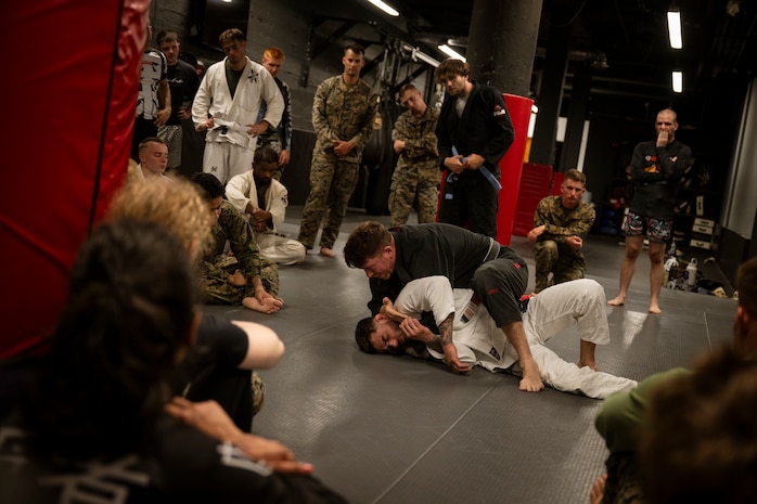 U.S. Marines assigned to Special Purpose Marine Air-Ground Task Force-250 learn Jiu-Jitsu techniques during a martial arts collaboration at Broadway Jiu-Jitsu during Marine Week Boston, Aug. 22, 2025. Marines stationed across the globe commemorate the 250th anniversary of the Marine Corps, honoring a distinguished legacy of service, sacrifice, and unwavering fidelity to both the nation and fellow Marines. (U.S. Marine Corps photo by Cpl. Vincent Needham)