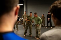 U.S. Marines assigned to Special Purpose Marine Air-Ground Task Force-250 demonstrate a wrist lock technique during a martial arts collaboration at Broadway Jiu-Jitsu during Marine Week Boston, Aug. 22, 2025. Marines stationed across the globe commemorate the 250th anniversary of the Marine Corps, honoring a distinguished legacy of service, sacrifice, and unwavering fidelity to both the nation and fellow Marines. (U.S. Marine Corps photo by Cpl. Vincent Needham)