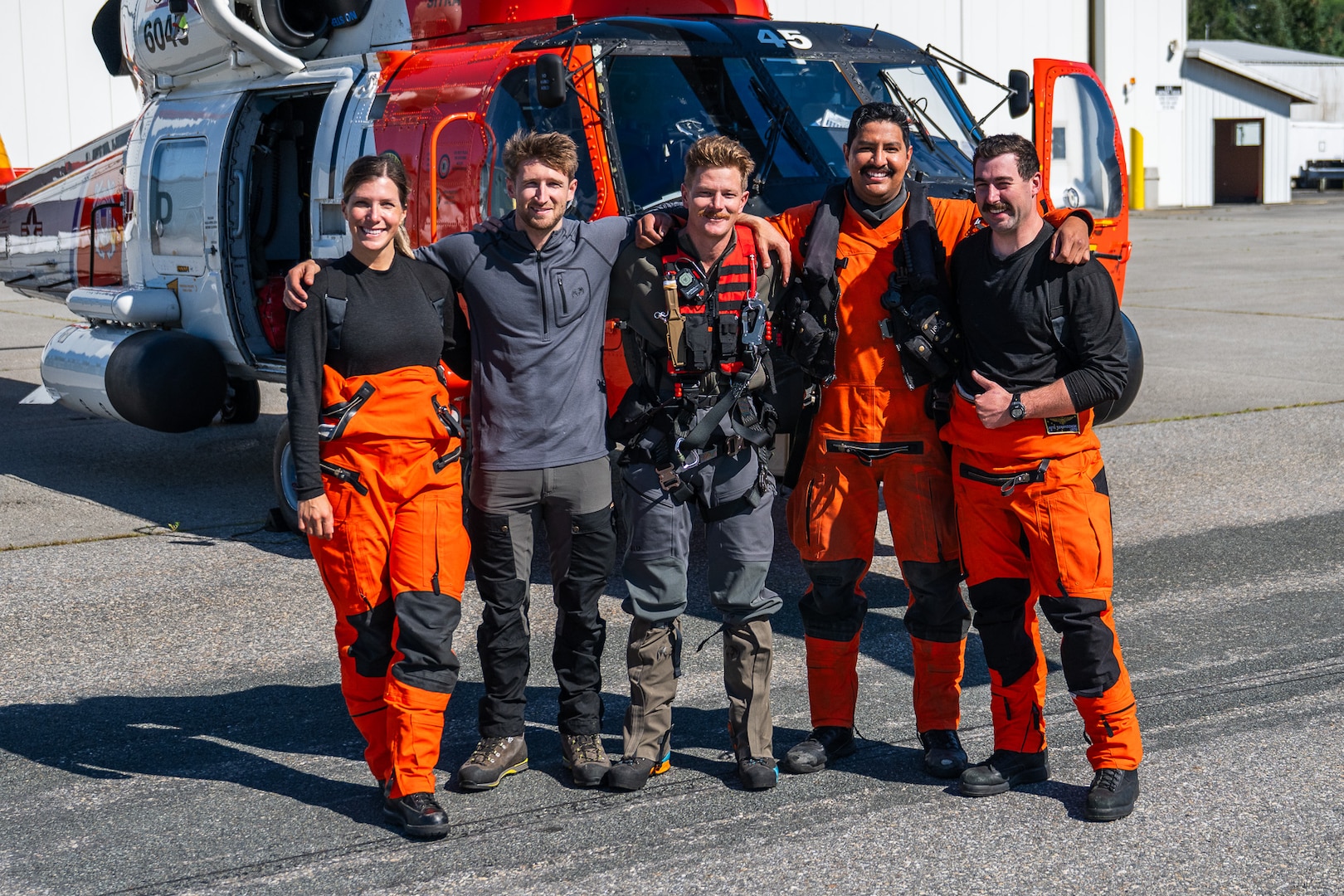A Coast Guard MH-60 Jayhawk helicopter aircrew from Coast Guard Air Station Sitka poses for a photo in Juneau, Alaska, after rescuing a pilot from a downed aircraft Aug. 24, 2025. The pilot was the only person aboard the downed aircraft and had no reported injuries. (U.S. Coast Guard photo by Chief Petty Officer Travis Magee)