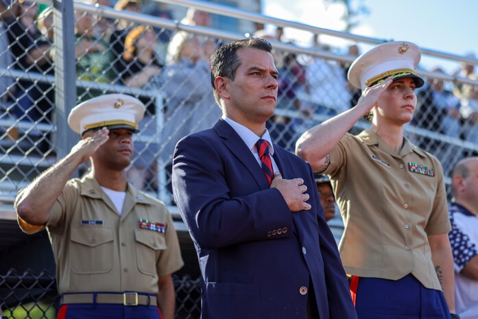 Jared C. Nicholson, center, the mayor of Lynn, Mass., Maj. Courtney Thompson, right, the commanding officer for Recruiting Station Boston, and Capt. Edgardo Diaz, left, the executive officer for RS Boston, stand for the national anthem prior to the RS Boston pool function during Marine Week Boston, Aug. 24, 2025. Pool Functions are held to build camaraderie while preparing future Marines for the mental and physical rigors of recruit training. During Marine Week Boston, Marines with Marine Corps Recruiting Command shared Marine Corps traditions with local high schools in honor of the Corps’ 250th birthday. Marines stationed across the globe commemorate the 250th anniversary of the Marine Corps, honoring a distinguished legacy of service, sacrifice, and unwavering fidelity to both the nation and fellow Marines. (U.S. Marine Corps photo by Sgt. Aidan Hekker)