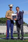 Jared C. Nicholson, right, the mayor of Lynn, Mass., presents a plaque and signed proclamation to Maj. Courtney Thompson, left, the commanding officer for Recruiting Station Boston, recognizing her efforts and the city’s support of the Marine Corps’ 250th birthday during Marine Week Boston, Aug. 24, 2025. Marines with Marine Corps Recruiting Command share their traditions with local high schools in honor of the Corps’ 250th birthday. In celebration of 250 years of proud tradition, Marines around the world unite to honor their shared heritage - a legacy defined by honor, courage, and commitment. (U.S. Marine Corps photo by Sgt. Aidan Hekker)