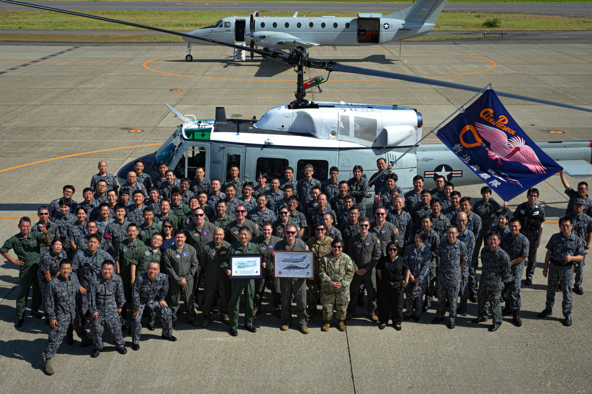 U.S. Air Force members assigned to the 459th Airlift Squadron and Japan Air Self-Defense Force members assigned to the Niigata Air Rescue Squadron pose for a group photo at Niigata Air Base, Japan, Aug. 8, 2025. The visit commemorated the units’ long-standing partnership and highlighted the importance of strong bilateral ties and continued cooperation.