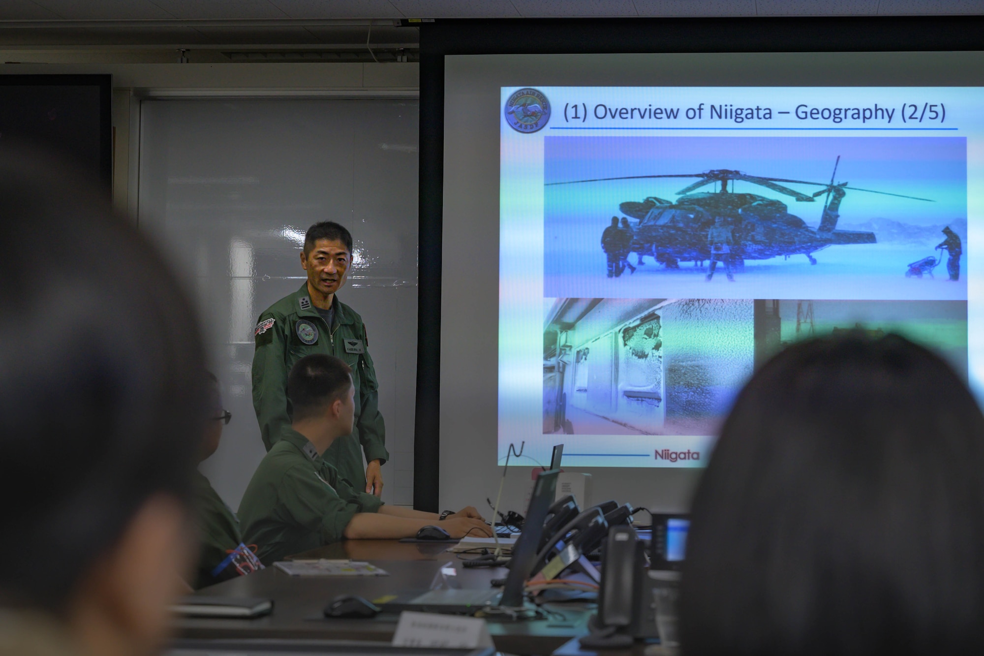 Japan Air Self-Defence Force Colonel Hiroshi Kageura, Niigata Air Rescue Squadron commander, gives an orientation brief to members assigned to the 459th Airlift Squadron at Niigata Air Base, Japan, Aug. 8, 2025. The visit commemorated the units’ long-standing partnership and highlighted the importance of strong bilateral ties and continued cooperation