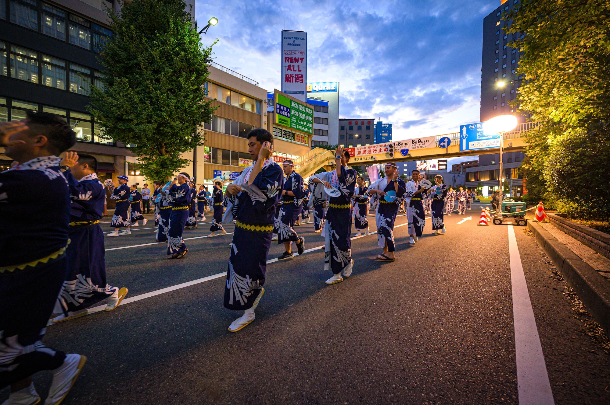 U.S. Air Force members assigned to the 459th Airlift Squadron and Japan Air Self-Defense Force members assigned to the Niigata Air Rescue Squadron perform a traditional Niigata dance during the Niigata festival, Aug. 8, 2025. The 459 AS visited Niigata Air Base to commemorate  the units’ long-standing partnership and highlight the importance of strong bilateral ties and continued cooperation