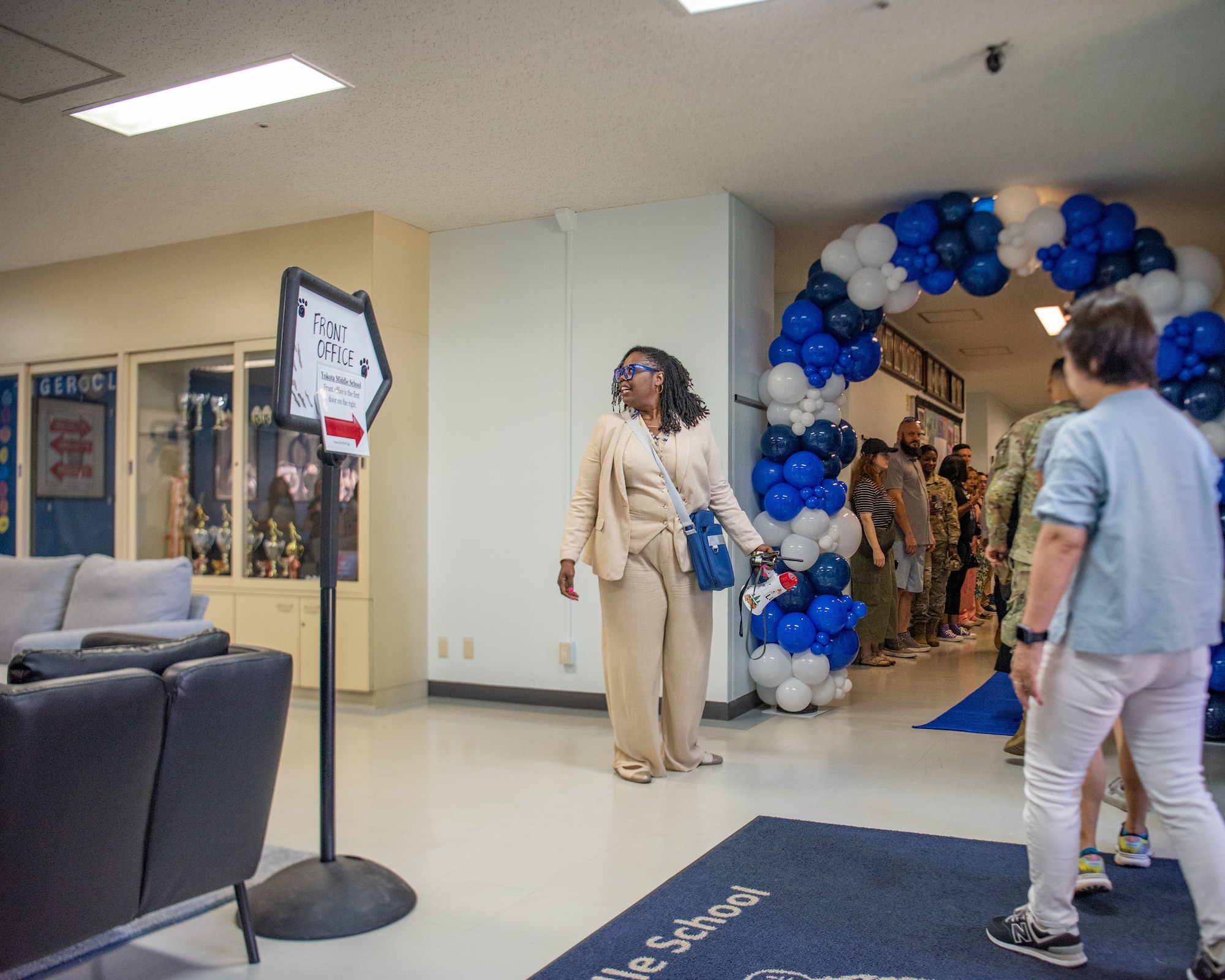 Parents wait a hallway for students to arrive.