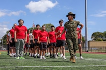 U.S. Marine Corps Sgt. Julie Leon, a drill instructor with Golf Company, 2nd Recruit Training Battalion, Marine Corps Recruit Depot Parris Island, teaches drill movements to poolees with Recruiting Station Boston during Marine Week Boston, Aug. 24, 2025. Pool Functions are held to build camaraderie while preparing future Marines for the mental and physical rigors of recruit training. Marines stationed across the globe commemorate the 250th anniversary of the Marine Corps, honoring a distinguished legacy of service, sacrifice, and unwavering fidelity to both the nation and fellow Marines. (U.S. Marine Corps photo by Sgt. Aidan Hekker)
