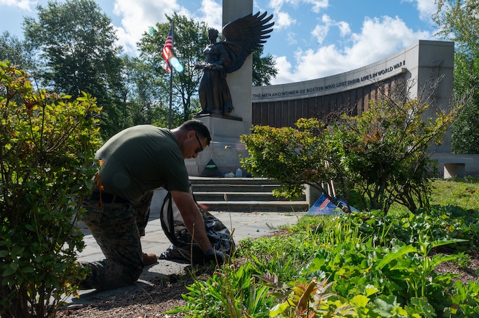 U.S. Marine Corps Gunnery Sgt. Benjamin Knight, a native of Hazen, N.D., an infantry unit leader assigned to Special Purpose Marine Air-Ground Task Force-250, pulls weeds at the World War II Memorial, Back Bay Fens park, during Marine Week Boston, Aug. 24, 2025. Marines stationed across the globe commemorate the 250th anniversary of the Marine Corps, honoring a distinguished legacy of service, sacrifice, and unwavering fidelity to both the nation and fellow Marines. (U.S. Marine Corps photo by Lance Cpl. Matthew A. McDonnell)