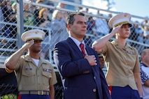 Jared C. Nicholson, center, the mayor of Lynn, Mass., Maj. Courtney Thompson, right, the commanding officer for Recruiting Station Boston, and Capt. Edgardo Diaz, left, the executive officer for RS Boston, stand for the national anthem prior to the RS Boston pool function during Marine Week Boston, Aug. 24, 2025. Pool Functions are held to build camaraderie while preparing future Marines for the mental and physical rigors of recruit training. During Marine Week Boston, Marines with Marine Corps Recruiting Command shared Marine Corps traditions with local high schools in honor of the Corps’ 250th birthday. Marines stationed across the globe commemorate the 250th anniversary of the Marine Corps, honoring a distinguished legacy of service, sacrifice, and unwavering fidelity to both the nation and fellow Marines. (U.S. Marine Corps photo by Sgt. Aidan Hekker)