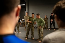 U.S. Marines assigned to Special Purpose Marine Air-Ground Task Force-250 demonstrate a wrist lock technique during a martial arts collaboration at Broadway Jiu-Jitsu during Marine Week Boston, Aug. 22, 2025. Marines stationed across the globe commemorate the 250th anniversary of the Marine Corps, honoring a distinguished legacy of service, sacrifice, and unwavering fidelity to both the nation and fellow Marines. (U.S. Marine Corps photo by Cpl. Vincent Needham)