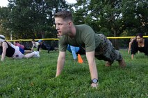 U.S. Marine Corps Sgt. Daniel Wahlgren, a native of Methuen, Mass., and a data systems operator assigned to Special Purpose Marine Air-Ground Task Force-250, preforms push-ups during Marine Week Boston, Aug. 23, 2025. Marines stationed across the globe commemorate the 250th anniversary of the Marine Corps, honoring a distinguished legacy of service, sacrifice, and unwavering fidelity to both the nation and fellow Marines. (U.S. Marine Corps photo by blank)