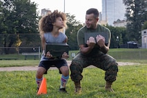 U.S. Marine Corps Sgt. Maj. Efrain Barrientos, right, a native of Princeton, N.J., assigned to Special Purpose Marine Air-Ground Task Force-250, motivates an event attendee during Marine Week Boston, Aug. 23, 2025. Marines stationed across the globe commemorate the 250th anniversary of the Marine Corps, honoring a distinguished legacy of service, sacrifice, and unwavering fidelity to both the nation and fellow Marines. (U.S. Marine Corps photo by blank)