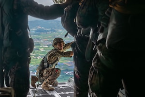 An individual over the open ramp of an aircraft
