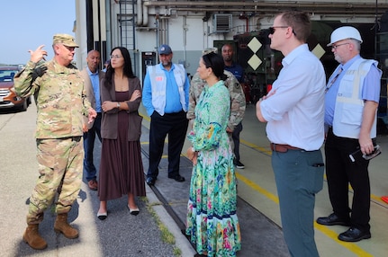 Army Lt. Col. Jon Neal, the commander of Army Field Support Battalion-Germany, (left) briefs professional staff members Alexa Lorick and Kim Segura from the U.S. Senate Committee on Appropriations, Subcommittee on Defense, outside one of the Coleman Army Prepositioned Stocks-2 facilities in Mannheim, Germany, August 13, 2025. (U.S. Army courtesy photo)