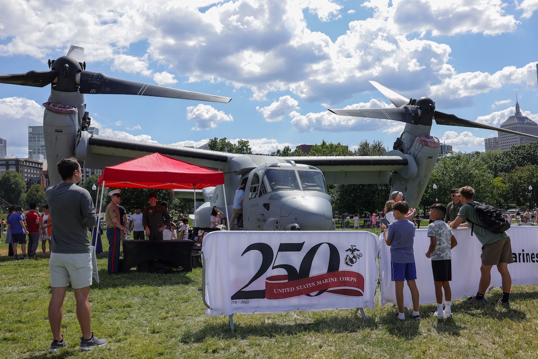 Event attendees line up to see an MV-22B Osprey attached to Marine Medium Tiltrotor Squadron (VMM) 774, 4th Marine Aircraft Wing, during Marine Week Boston, Aug. 23, 2025. Marines with Marine Corps Recruiting Command share their traditions with local high schools in honor of the Corps’ 250th birthday. In celebration of 250 years of proud tradition, Marines around the world unite to honor their shared heritage - a legacy defined by honor, courage, and commitment. (U.S. Marine Corps photo by Sgt. Aidan Hekker)
