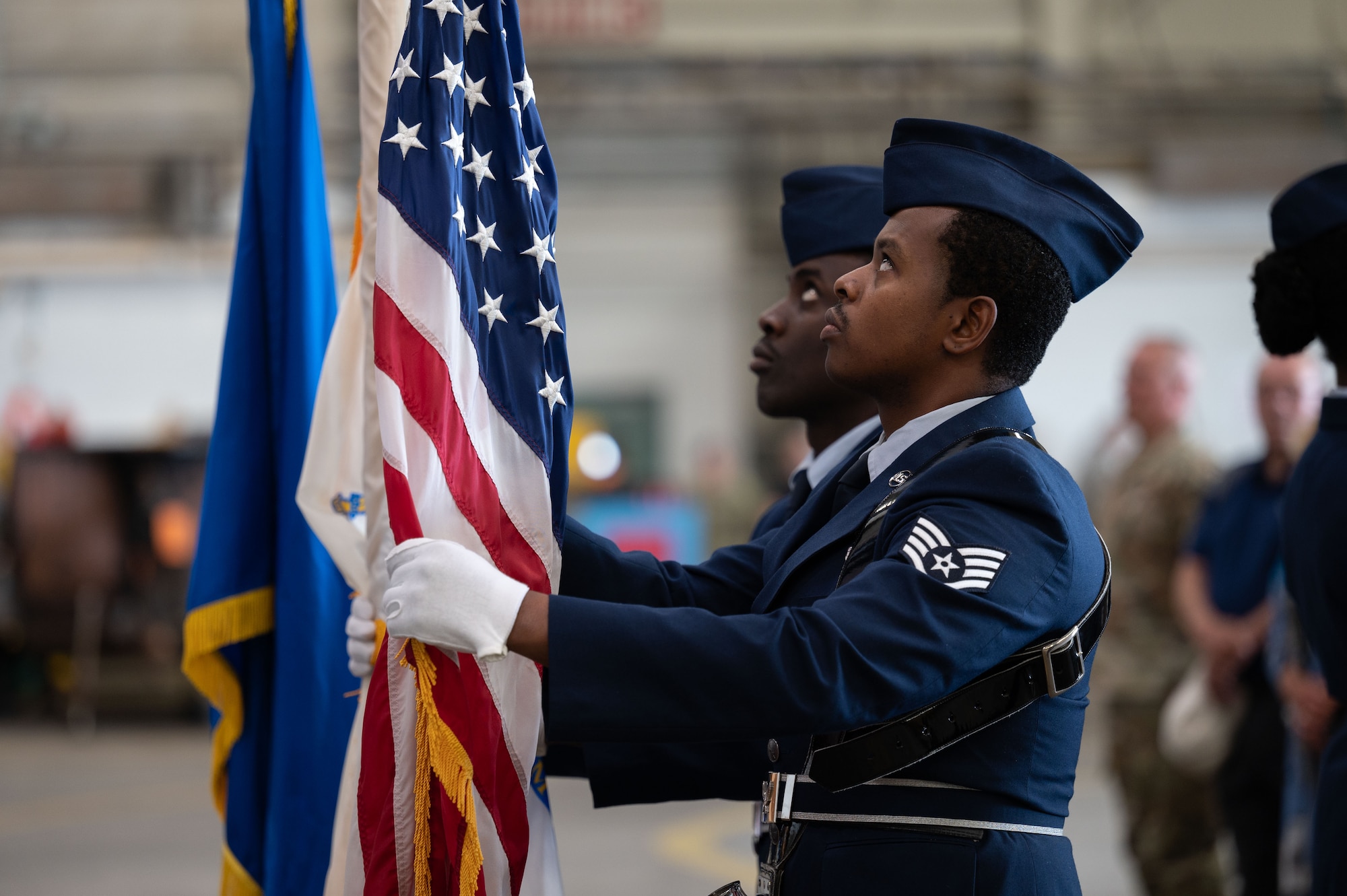 Airmen adjust the flag.