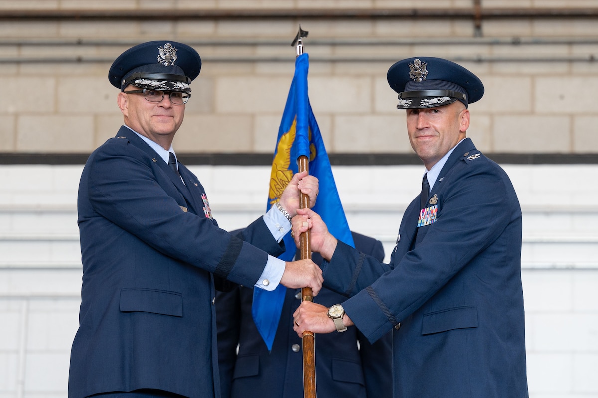 Airmen pass the guidon.