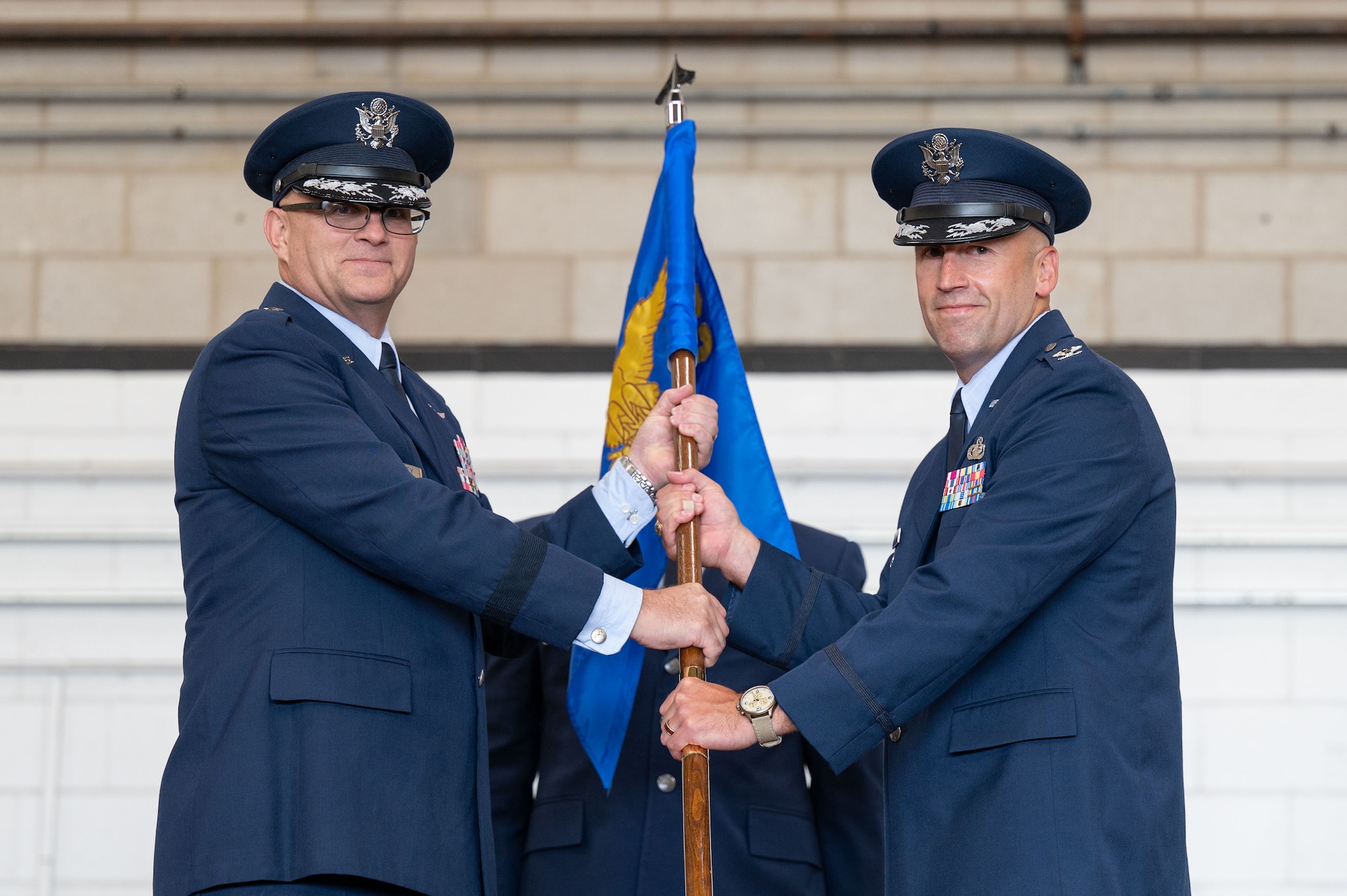 Airmen pass the guidon.