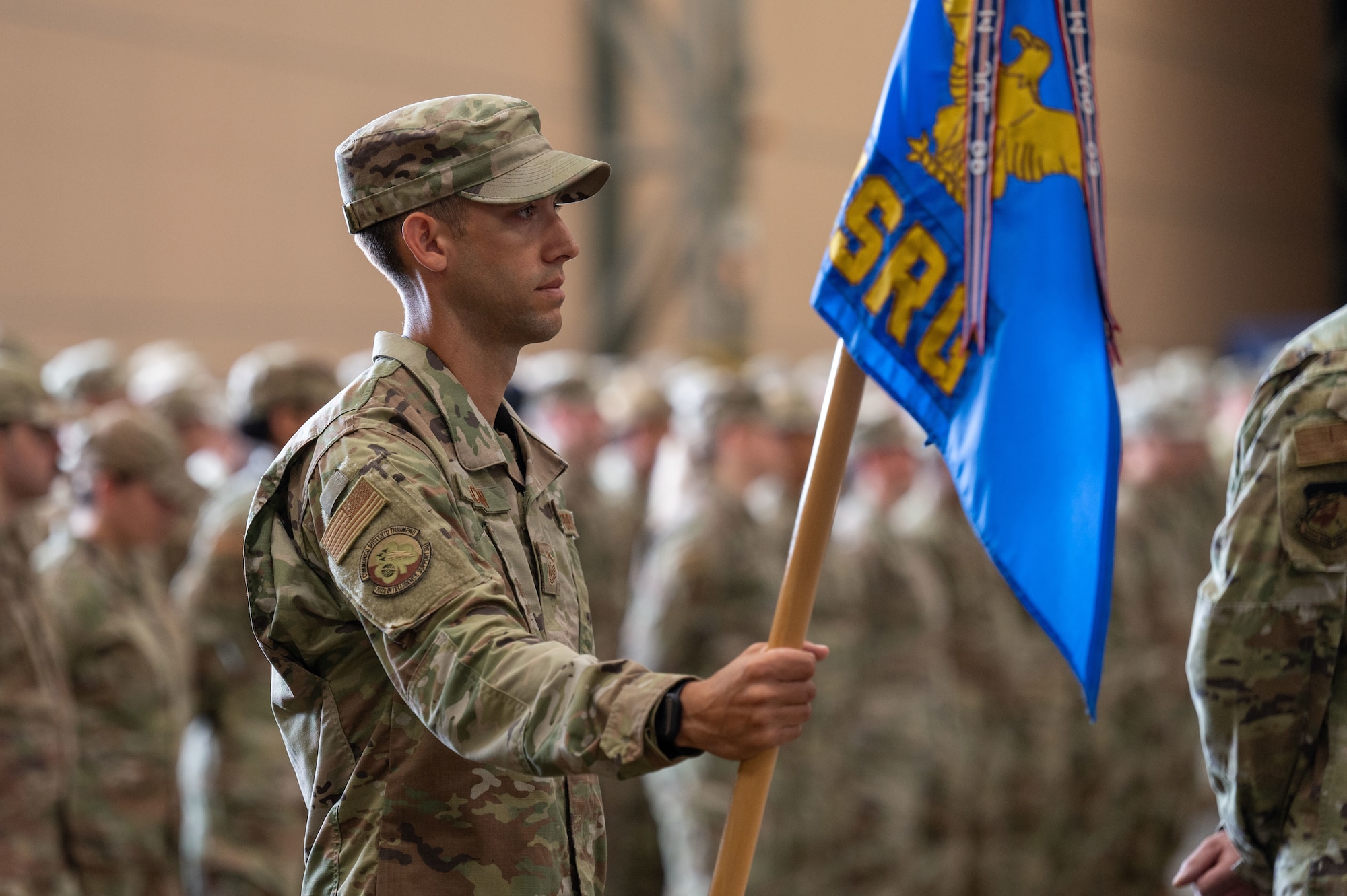 Airmam holds a guidon.