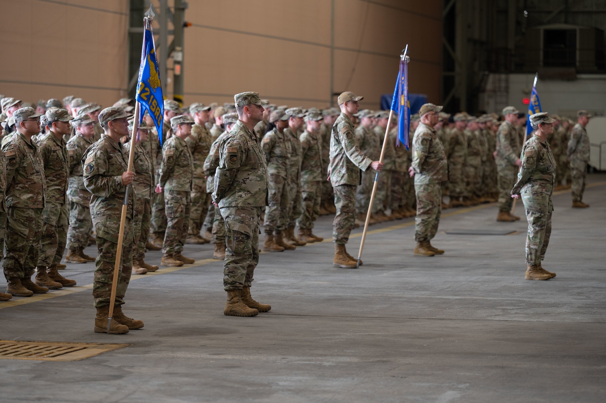 Airmen stand at attention.