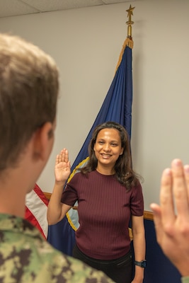 BOSTON (August 12, 2025) – Dr. Basmah Jalil, center, from Karachi, Pakistan, commissions into the United States Navy Medical Corps at Navy Talent Acquisition Group Headquarters in Boston. NTAG New England supports NRC’s mission in Massachusetts, Connecticut, Rhode Island, Vermont, New Hampshire, and eastern New York. (U.S. Navy photo by Mass Communication Specialist 2nd Class Michael J. Cintron)