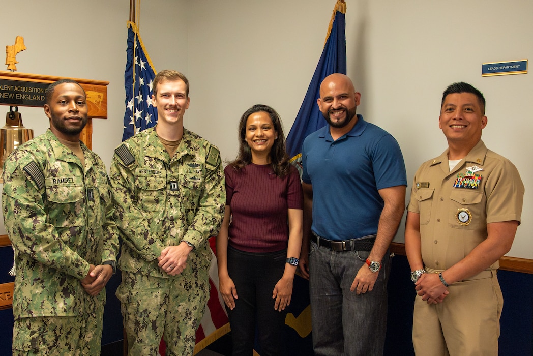 BOSTON (August 12, 2025) – Dr. Basmah Jalil, center, from Karachi, Pakistan, her husband, second from right, and officer recruiters assigned to Navy Talent Acquisition Group New England pose for a photo after her commissioning into the United States Navy Medical Corps at Navy Talent Acquisition Group Headquarters in Boston. NTAG New England supports NRC’s mission in Massachusetts, Connecticut, Rhode Island, Vermont, New Hampshire, and eastern New York. (U.S. Navy photo by Mass Communication Specialist 2nd Class Michael J. Cintron)