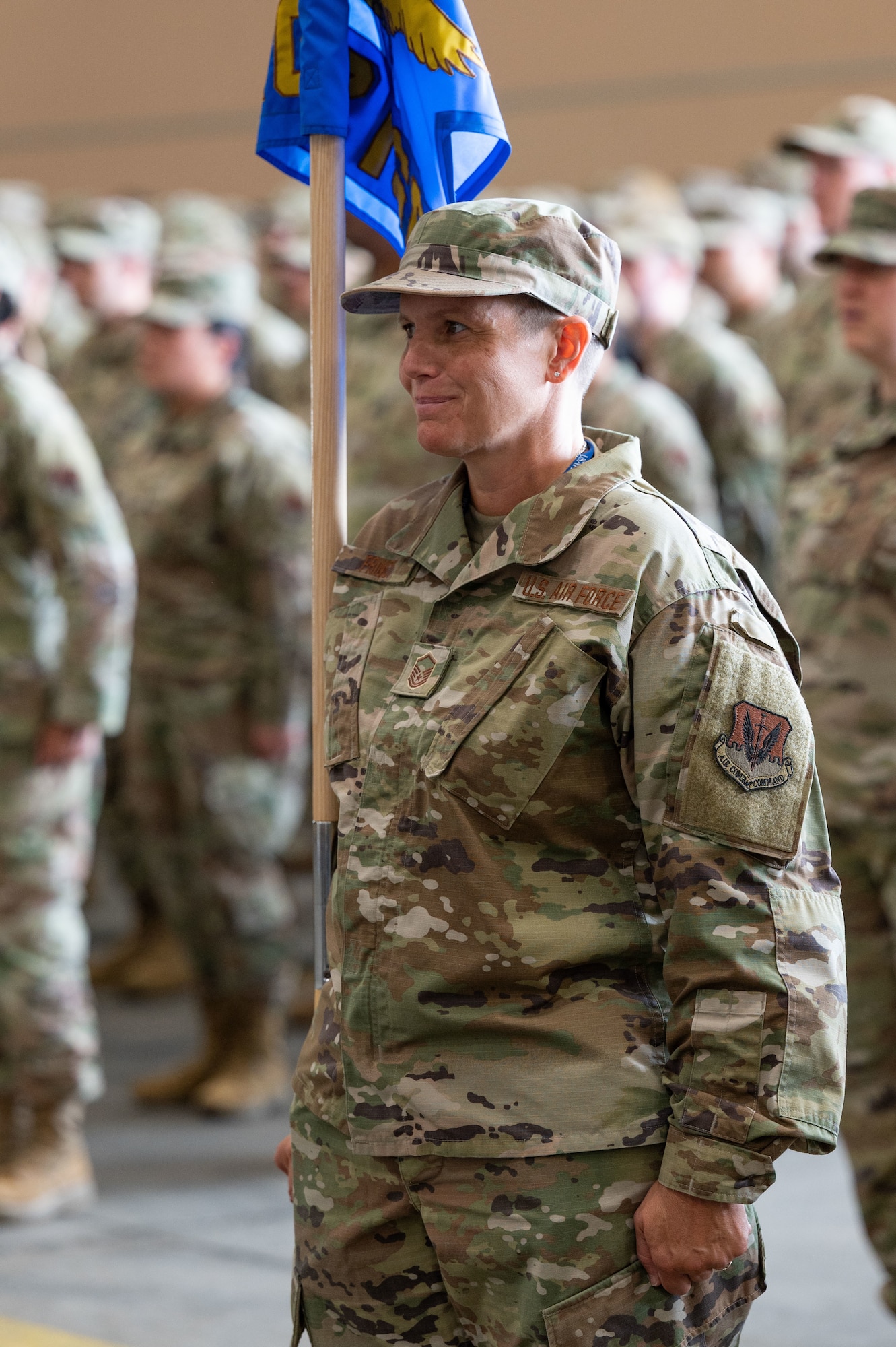 Airman holds a guidon.