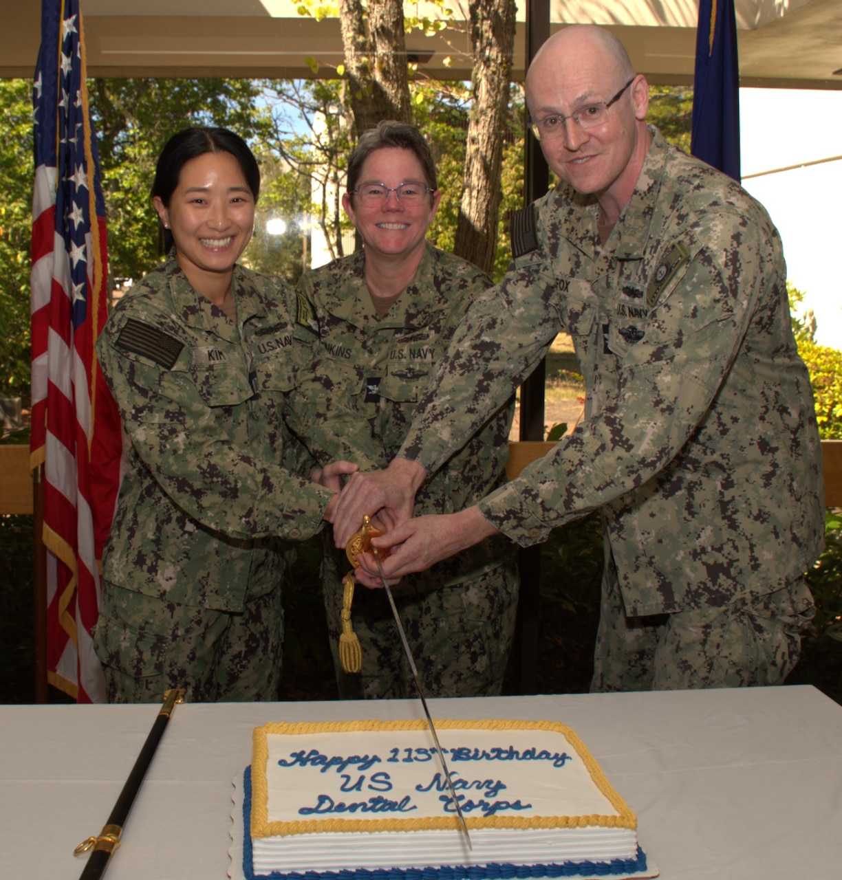 A slice of 113 years… Capt. Molly Jenkins, Navy Medicine Readiness Training Command Bremerton executive officer and Dental Corps officer is flanked by Capt. Patrick Fox, staff dental officer (right) and Lt. Bueniel Kim, general dentist, in the traditional cake cutting ceremony held in recognition of their birth, Aug. 22, 1912. There are approximately 1,400 active duty and reserve dentists in Navy Medicine, accomplished in 15 specialties which include such disciplines as comprehensive dentistry, dental and biomedical research, dental public health, endodontics, forensic odontology, maxillofacial prosthetics, operative dentistry, oral and maxillofacial pathology, oral medicine and radiology, orofacial pain, orthodontics, pediatric dentistry, periodontics, oral and maxillofacial surgery and prosthodontics (official Navy photo by Mass Communication Specialist 2nd Class Jennifer Benedict, NHB/NMRTC Bremerton public affairs).