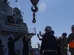Sailors aboard the Arleigh Burke-class guided-missile destroyer USS Higgins (DDG 76) simulate loading ammunition from a barge during Noble Prime 25-3 in the Cleveland Bay, Australia, July 28.