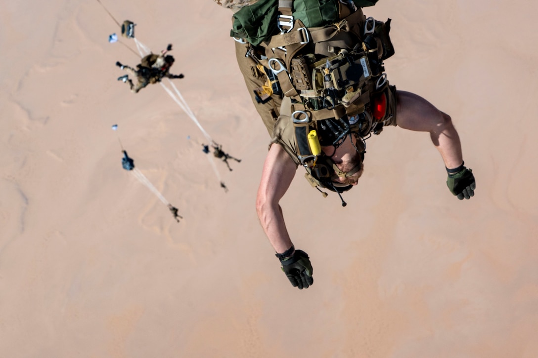 A U.S. Air Force pararescueman, 52nd Expeditionary Rescue Squadron jump master, performs a military free fall in the U.S. Central Command area of responsibility, Aug. 5, 2025. The ongoing training efforts of the 52 ERQS reflect the Air Force's commitment to excellence in rescue operations and regional stability across the CENTCOM region. (U.S. Air Force photo by Senior Airman Natalie Jones)