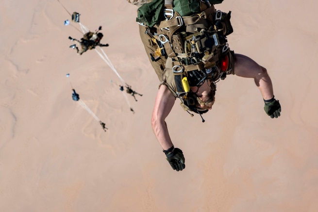 A U.S. Air Force pararescueman, 52nd Expeditionary Rescue Squadron jump master, performs a military free fall in the U.S. Central Command area of responsibility, Aug. 5, 2025. The ongoing training efforts of the 52 ERQS reflect the Air Force's commitment to excellence in rescue operations and regional stability across the CENTCOM region. (U.S. Air Force photo by Senior Airman Natalie Jones)