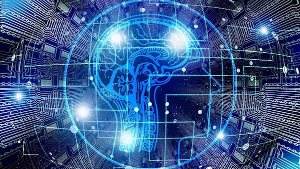 Digital illustration of a human head profile, overlaid on a digital background of electronic circuits, symbolizing artificial intelligence and the fusion of technology with the human mind.