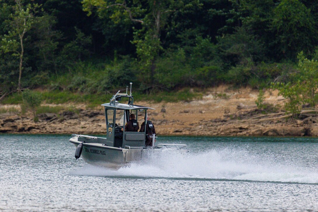 A boat drives along a lake.