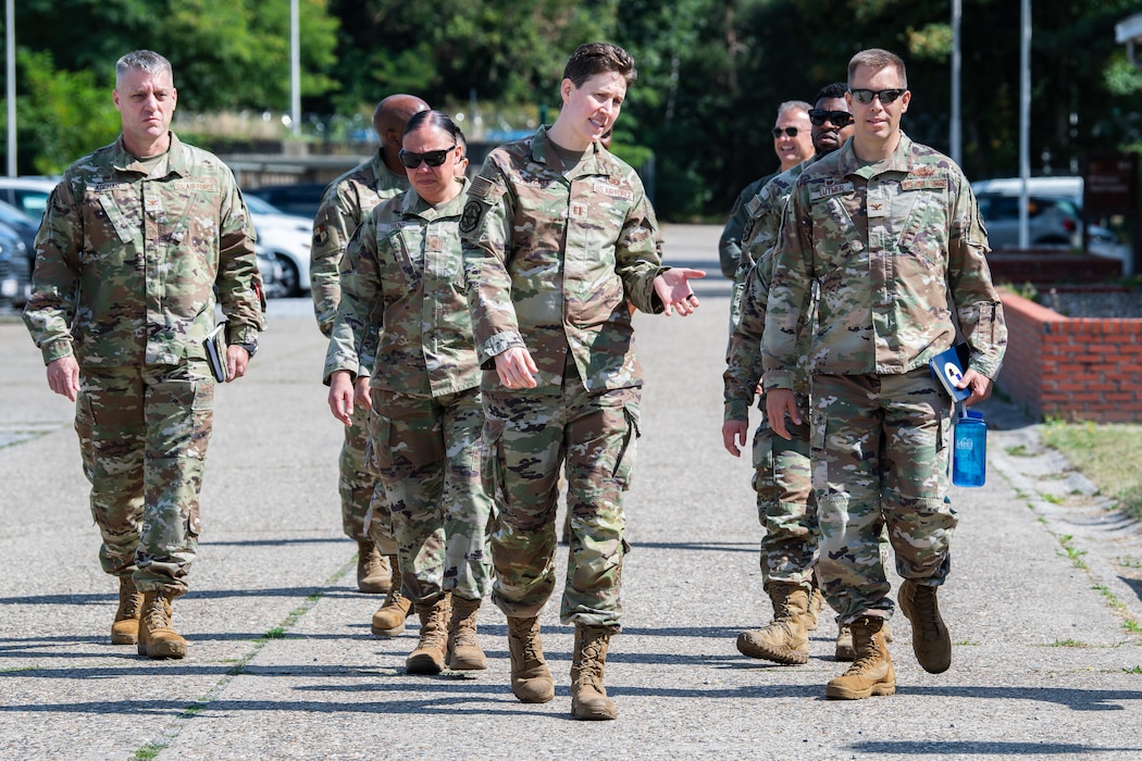 A group of Airmen walk down a road