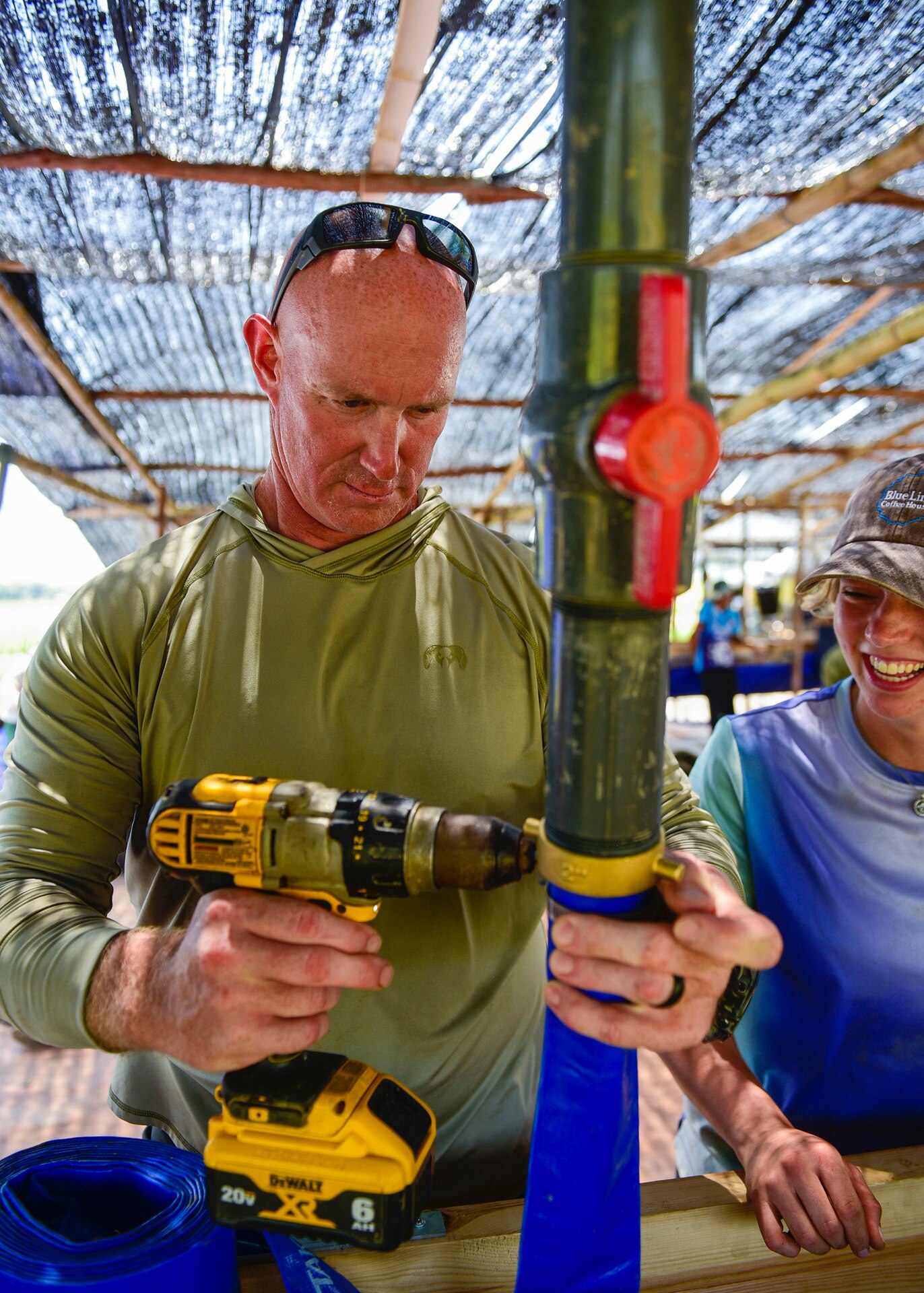 Master Sgt. Dustin Turner, an explosive ordnance disposal technician assigned to the Kentucky Air National Guard’s 123rd Civil Engineer Squadron, secures a pipe as part of a sifting system to screen wet top soil for osseous material in Quang Binh Province, Vietnam, in June 2023.