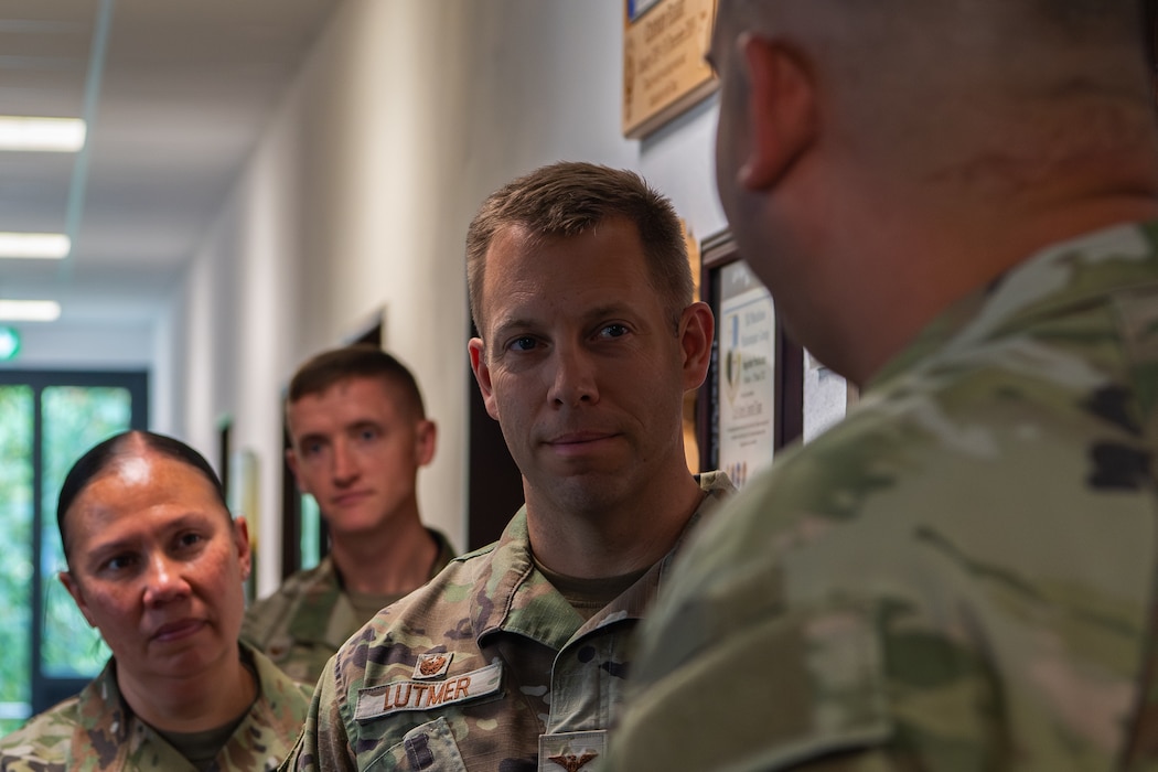 An Air Force colonel speaks with an Airman