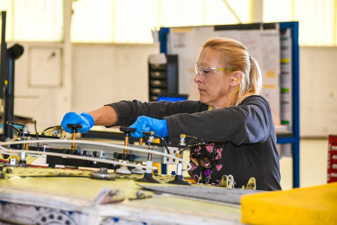 250327-N-DG679-1049
JACKSONVILLE, Fla. (March 27, 2025) Charlotte Miller, a sheet metal mechanic at Fleet Readiness Center Southeast (FRCSE), prepares to use a drill guide fixture on the center wing section to create precise holes during service life extension program upgrades on a T-45 Goshawk wing. The T-45 Goshawk is a jet trainer aircraft used by the U.S. Navy and Marine Corps for intermediate and advanced pilot training. (U.S. Navy photo by Toiete Jackson)